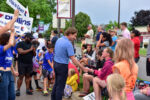 Dean Phillips speaks to a voter at a parade. Dean Phillips speaks to a voter at a parade.